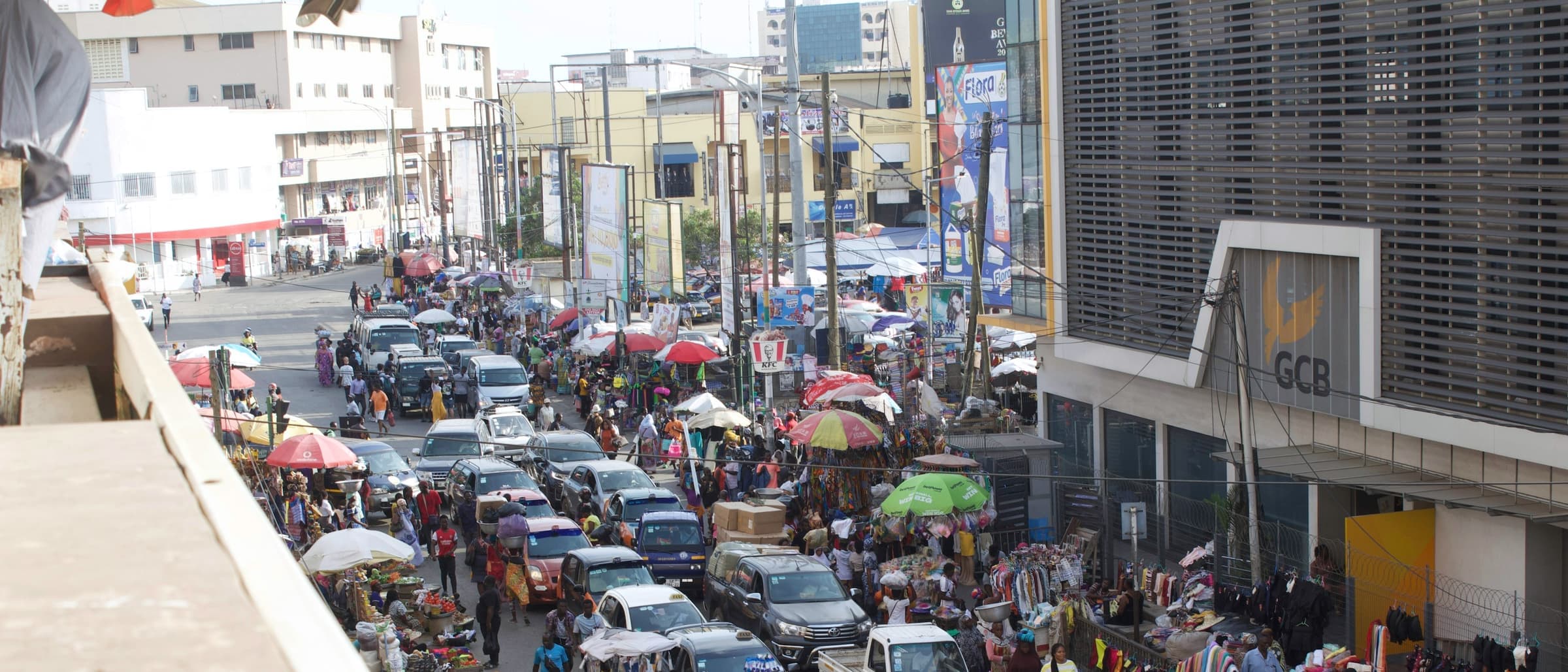 Traffic and street traders on a busy commercial road in central Accra