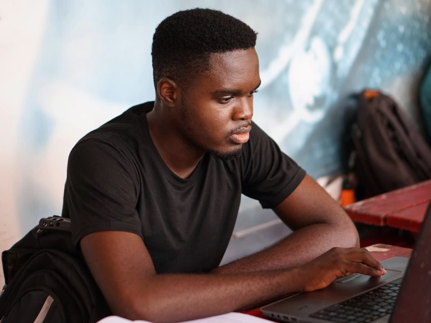 A student working on a laptop in a classroom